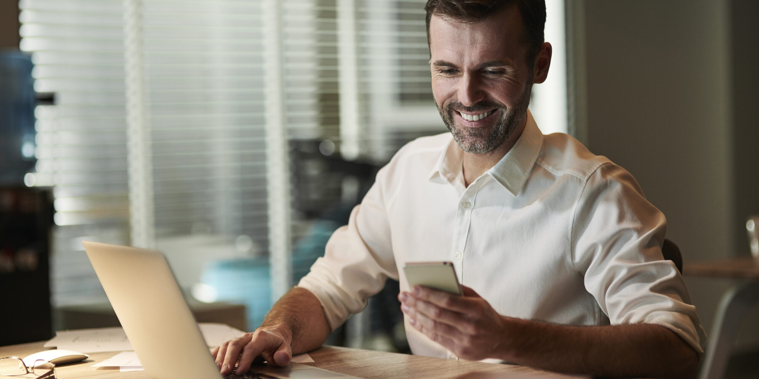 Multitasking businessman working at night